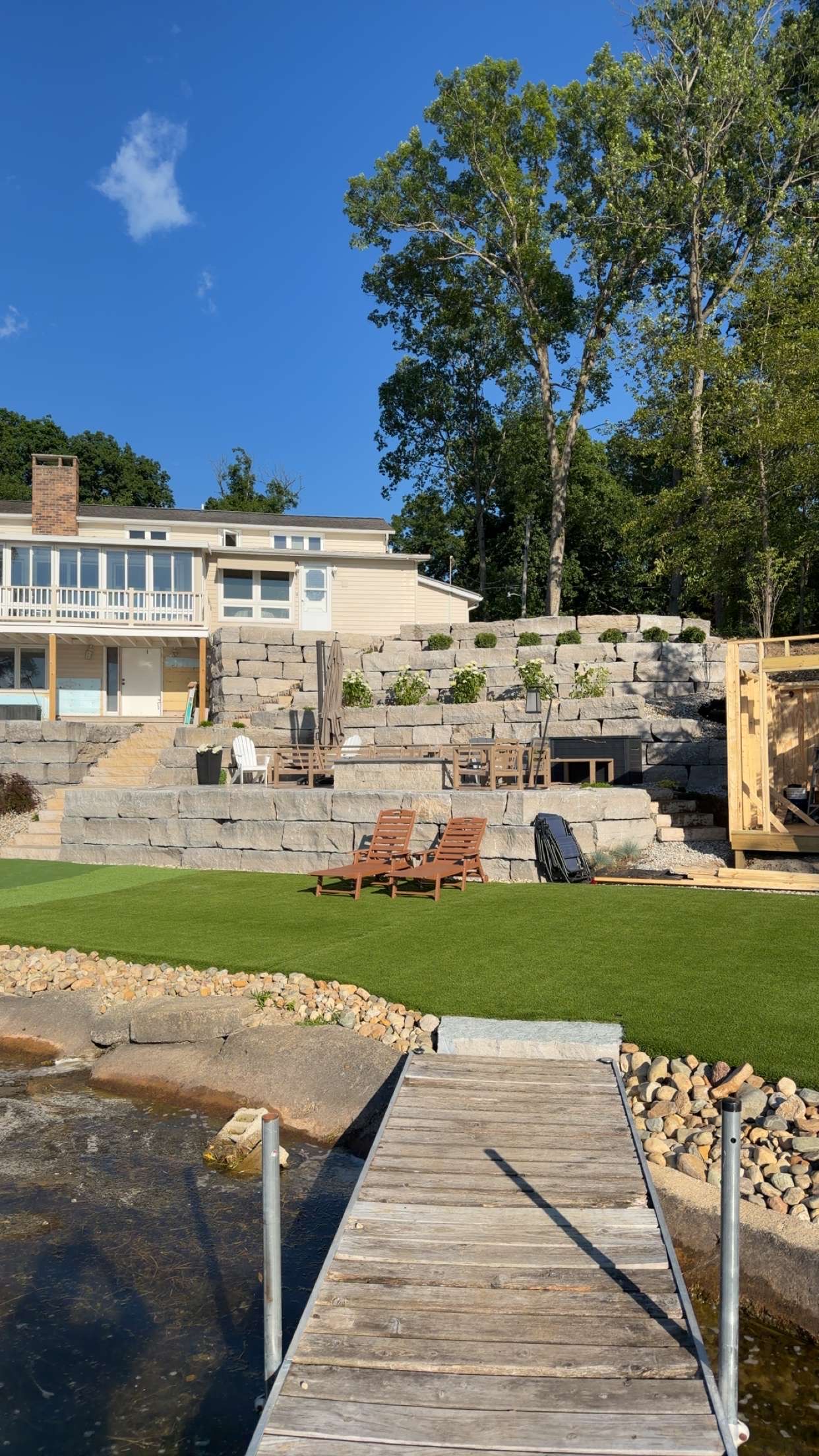 Complete transformation showcase of lakeside retaining wall and patio