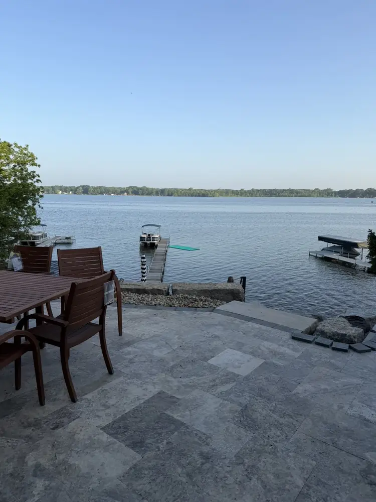 Custom paver patio installation adjacent to Duck Lake retaining wall