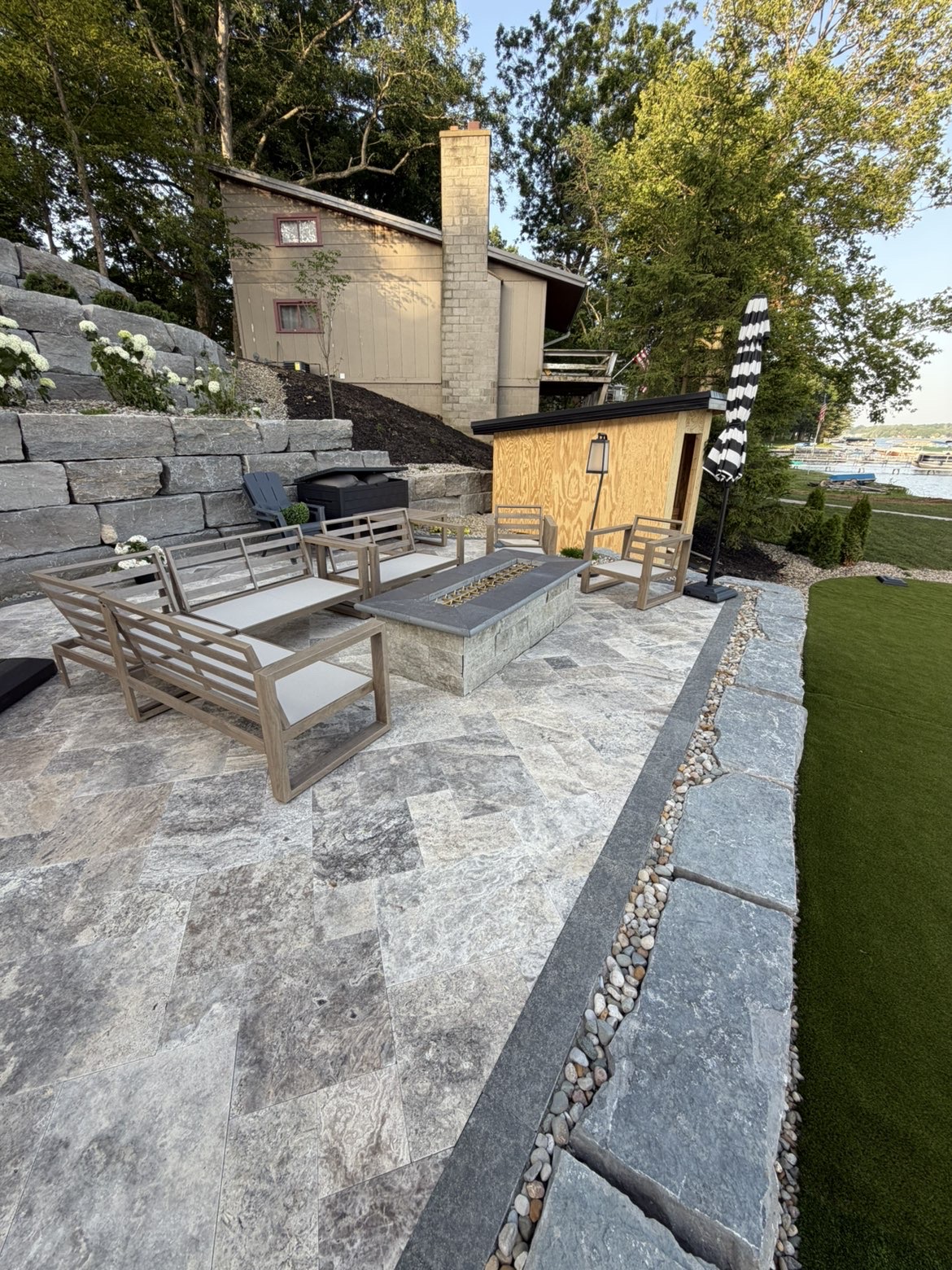 Wide angle perspective of lakeside patio and shoreline wall