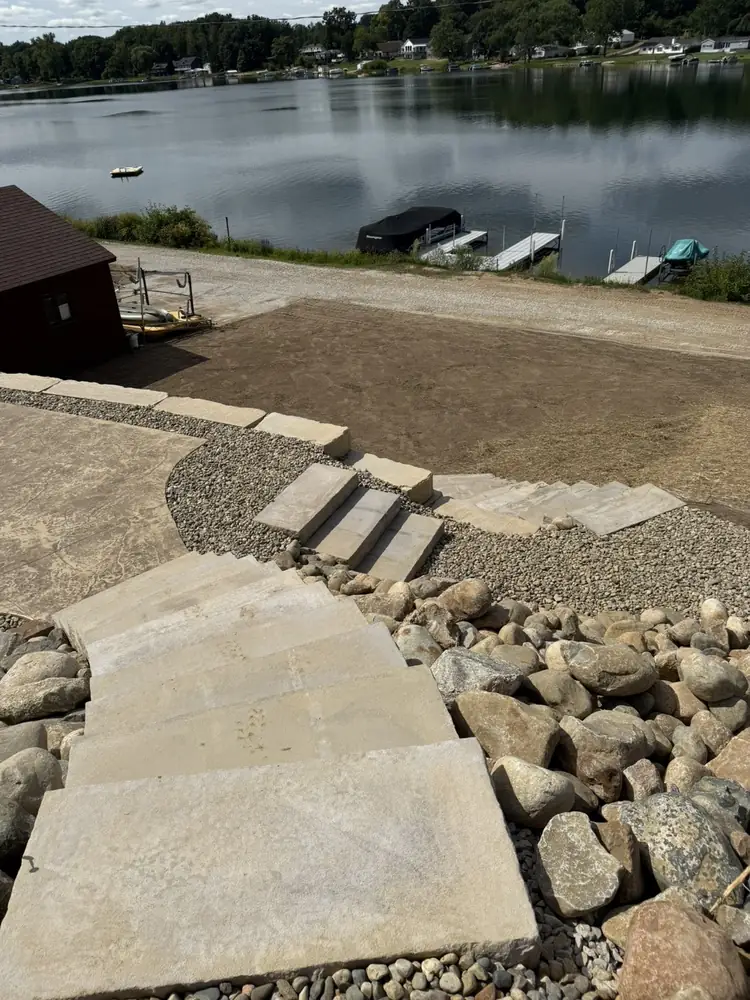 Complete transformation overview of hillside retaining walls and patio area