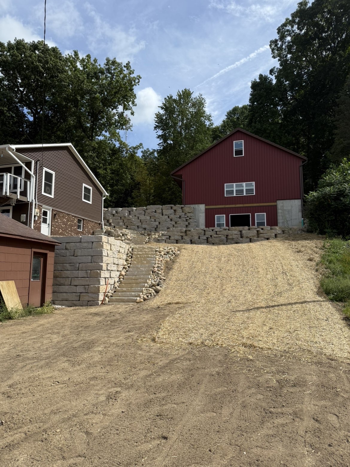 Structural retaining wall excavation and hillside slope management