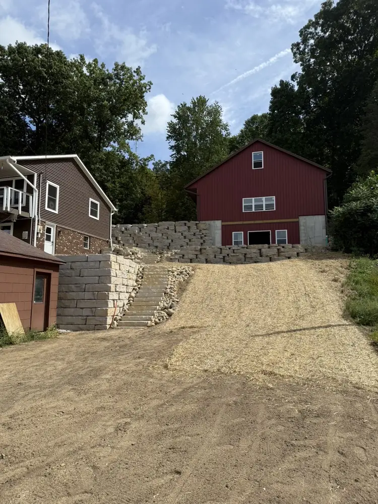 Structural retaining wall excavation and hillside slope management