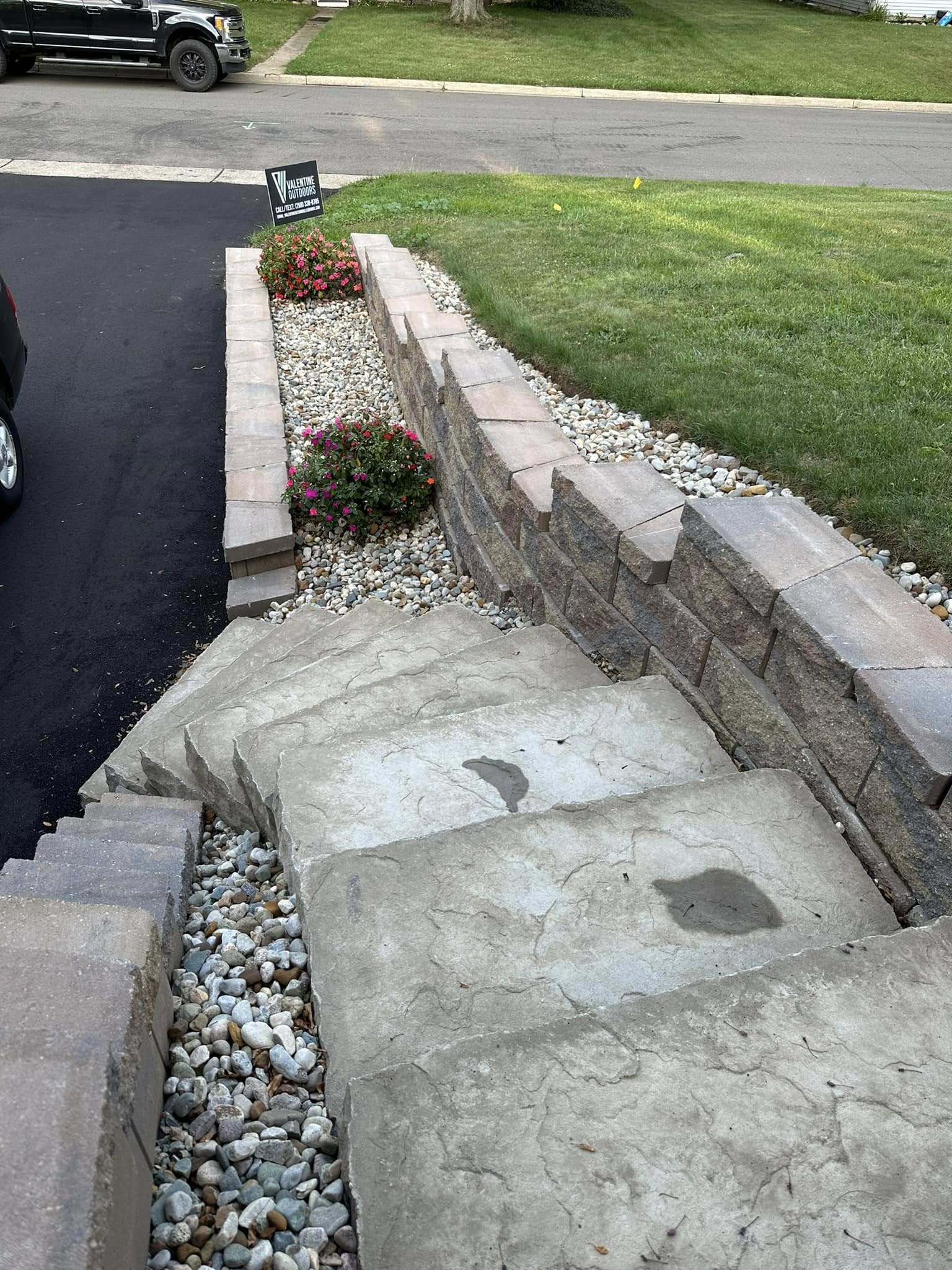 Custom brick paver patio installation with stone border design in Marshall, MI