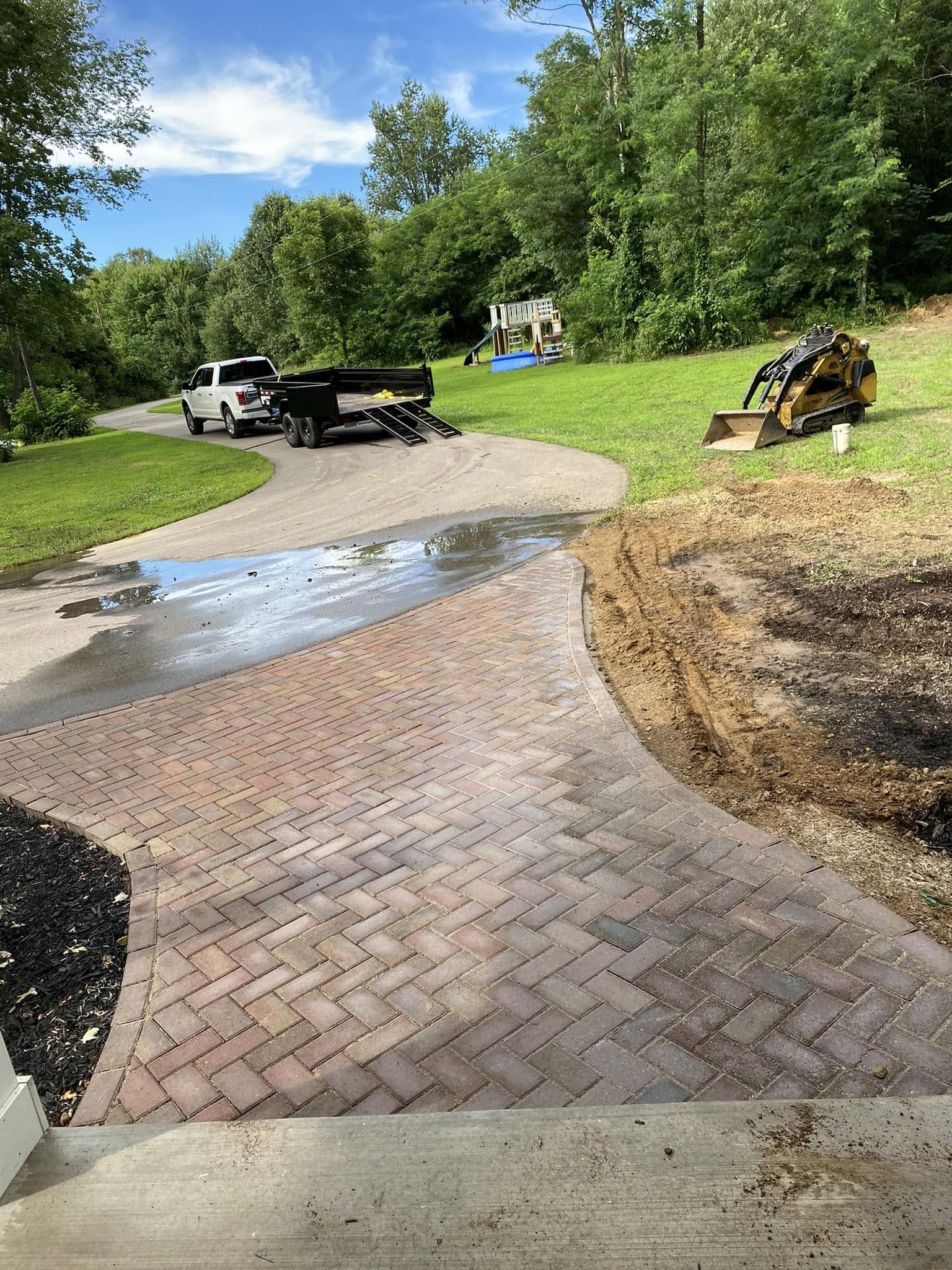 Outdoor living space featuring built-in fire pit and paver patio