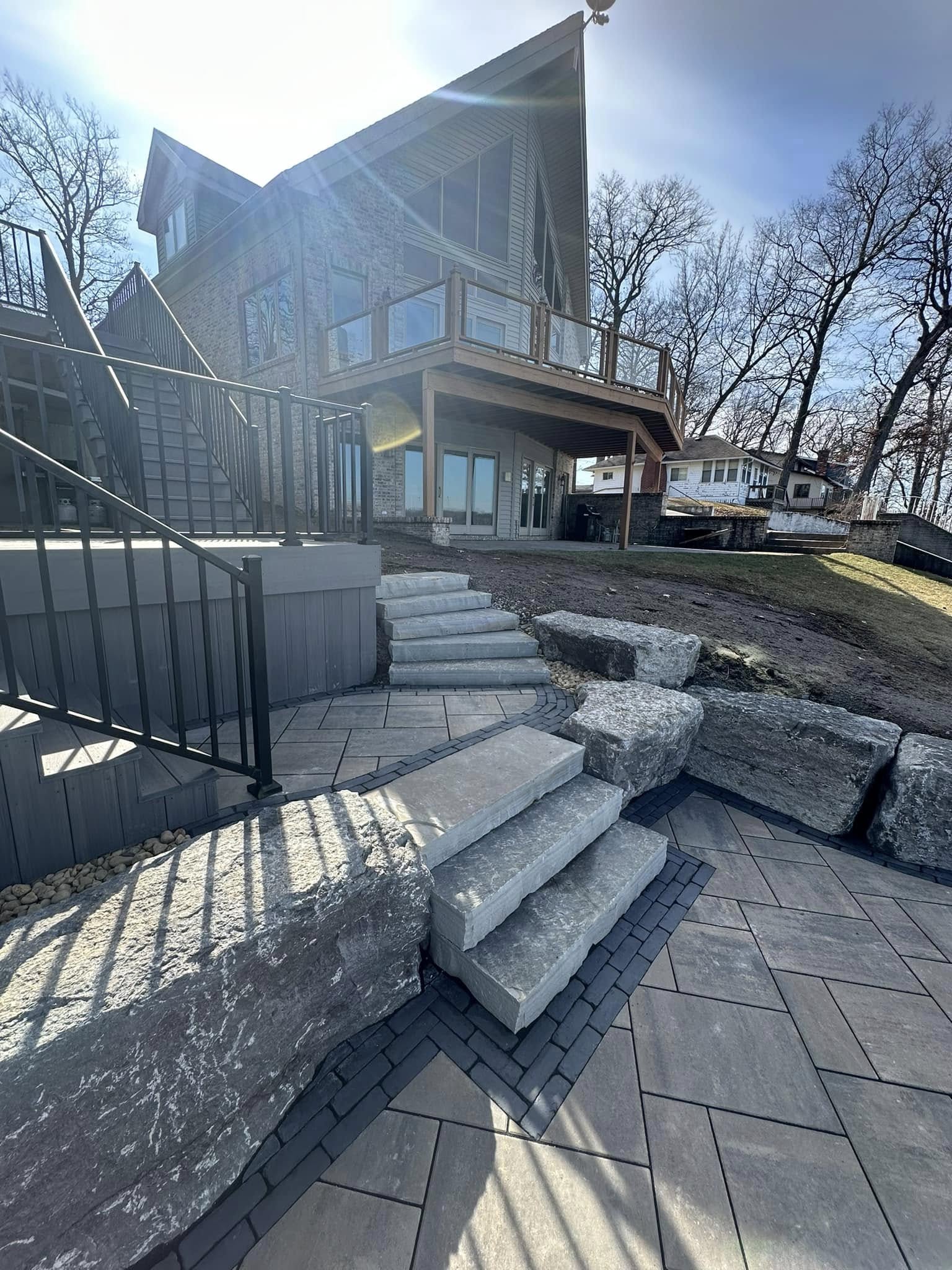 Multi-tiered retaining wall system with integrated landscape lighting