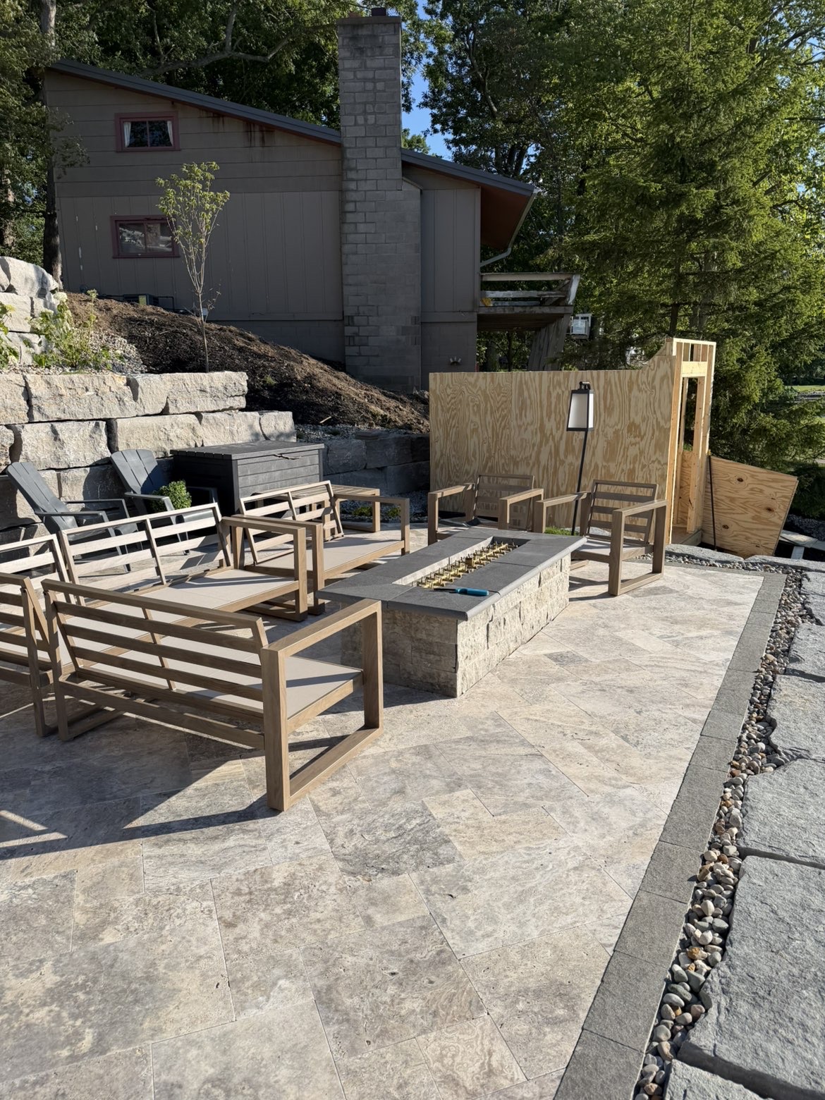 Custom stone seating wall constructed around outdoor patio area