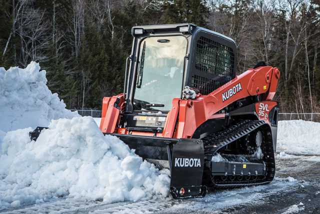 Residential driveway snow management truck clearing winter accumulation